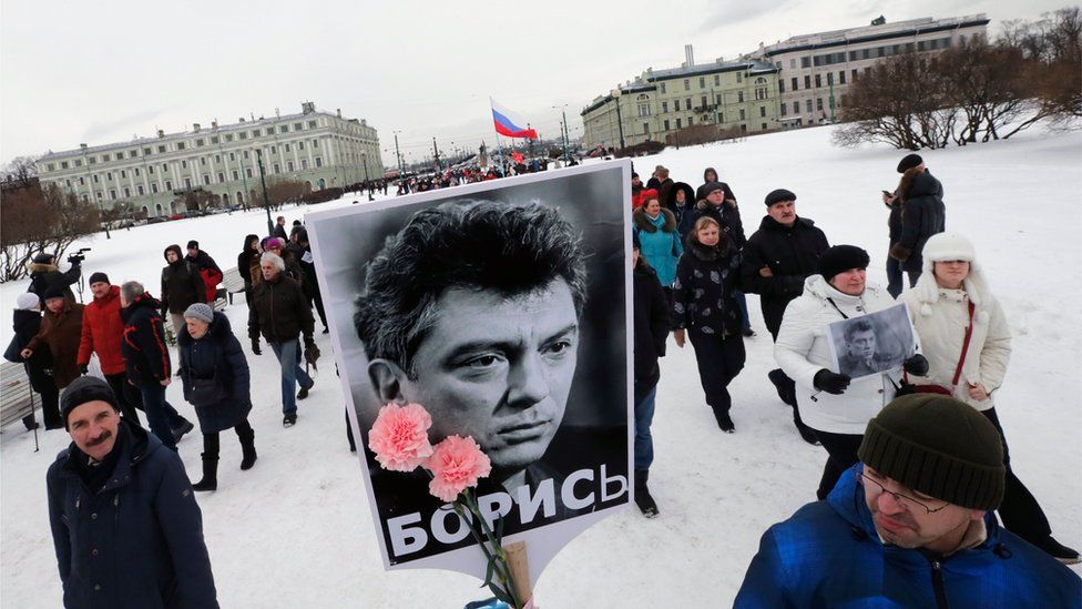 Russian people participate in a memorial march for Boris Nemtsov in St Petersburg