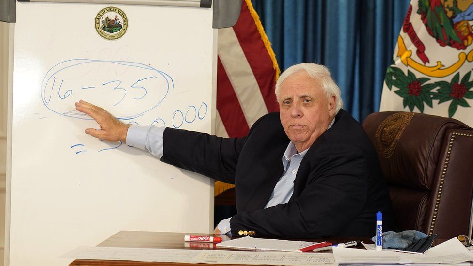 West Virginia's governor speaks at a news conference.