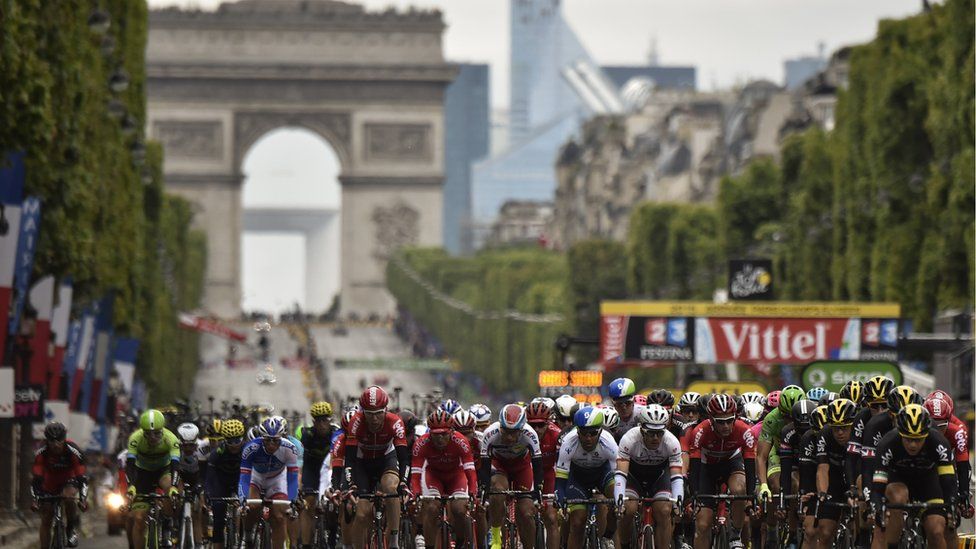 Cyclists in the Tour de France head down the Champs Elysees in Paris