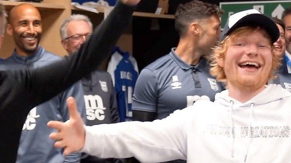 Ipswich Town Football Club players sing to Ed Sheeran in dressing room.