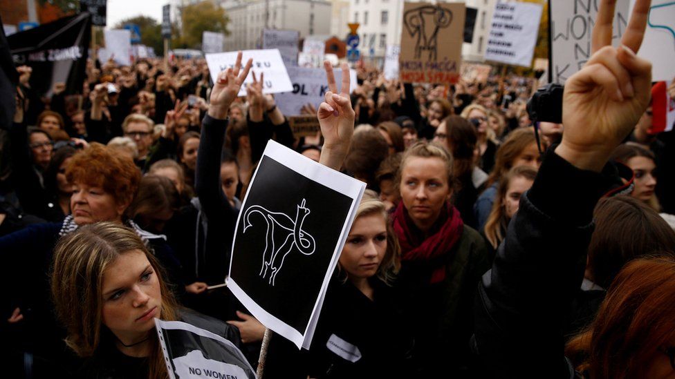 Women gesture as people gather in an abortion rights campaigners' demonstration to protest against plans for a total ban on abortion in front of the ruling party Law and Justice (PiS) headquarters in Warsaw, Poland 3 October 2016.