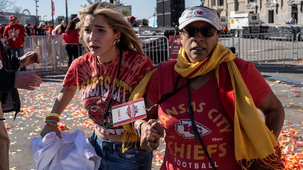 People flee after shots were fired near the Kansas City Chiefs' Super Bowl LVIII victory parade on February 14, 2024, in Kansas City, Missouri
