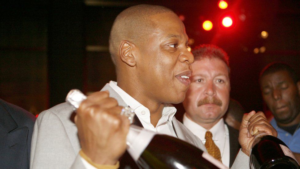 Jay-Z holding champagne