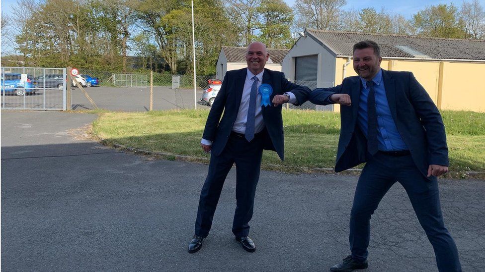 Conservatives Paul Davies and Sam Kurtz celebrating with an elbow bump in Haverfordwest