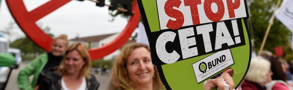 Consumer rights activists hold banners to protest against the Comprehensive Economic and Trade Agreement (CETA)