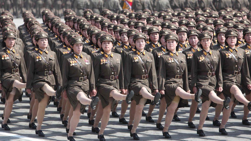 Row of marching female soldiers in skirts