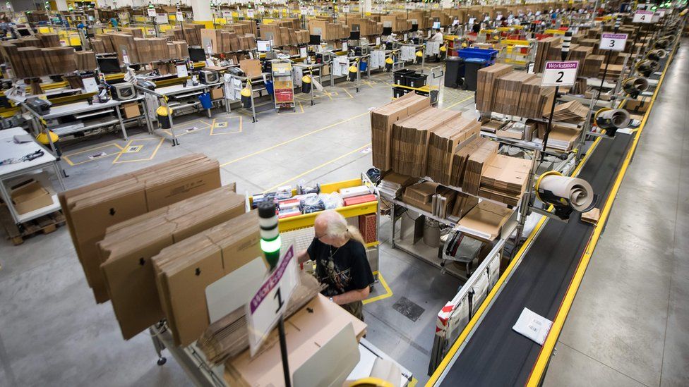Employees of American electronic commerce company Amazon prepare items for dispatch in Bad Hersfeld, central Germany on December 7, 2017.