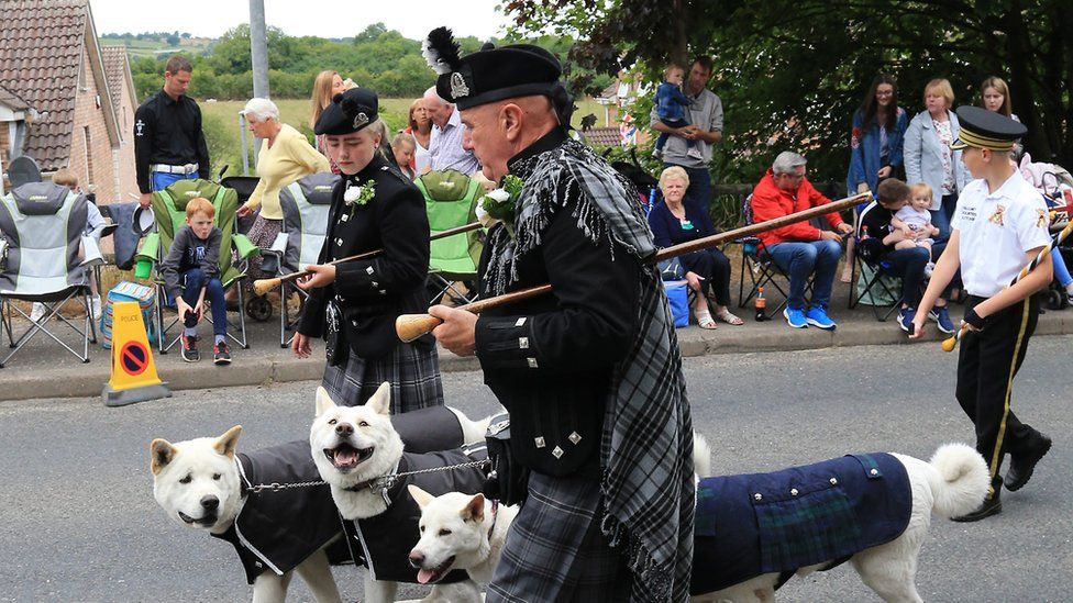 Band members walk their dogs at the Scarva Sham Fight