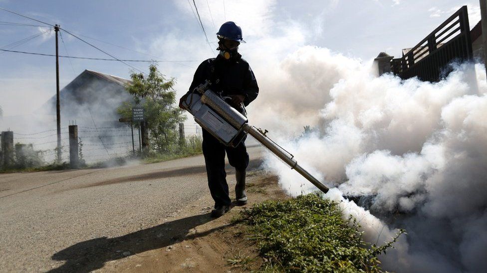 An Indonesian health worker sprays pesticide in a residential area which is suspected to be endemic area for mosquitos, in order to prevent the spread of dengue feaver and the possible spread of the Zika virus in Banda Aceh, Indonesia, 1 September 2016.
