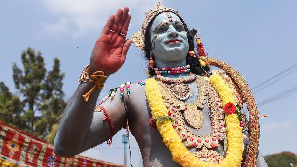 An Indian artist dressed as Lord Rama, a character from a Hindu mythological epic poem entitled Ramayana, gestures during Hanuman Jayanti festival in Bangalore on December 20, 2018.