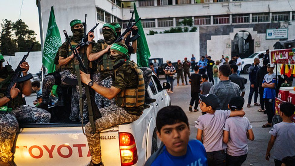Hamas militants provide security at an event where Yahya Sinwar, Palestinian leader of Hamas makes an appearance
