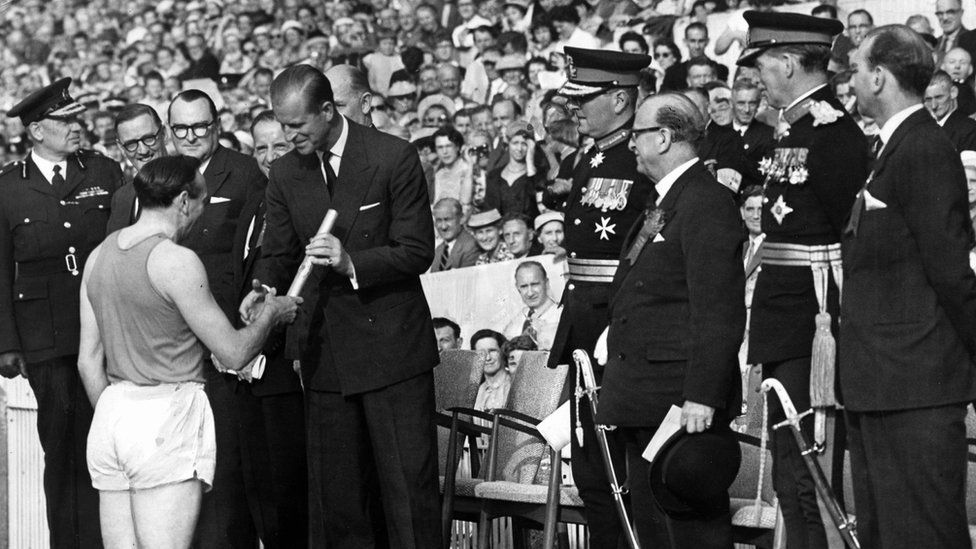 Ken Jones hands Queen's Baton to Duke of Edinburgh at the opening of the Empire Games at Cardiff Arms Park in 1958