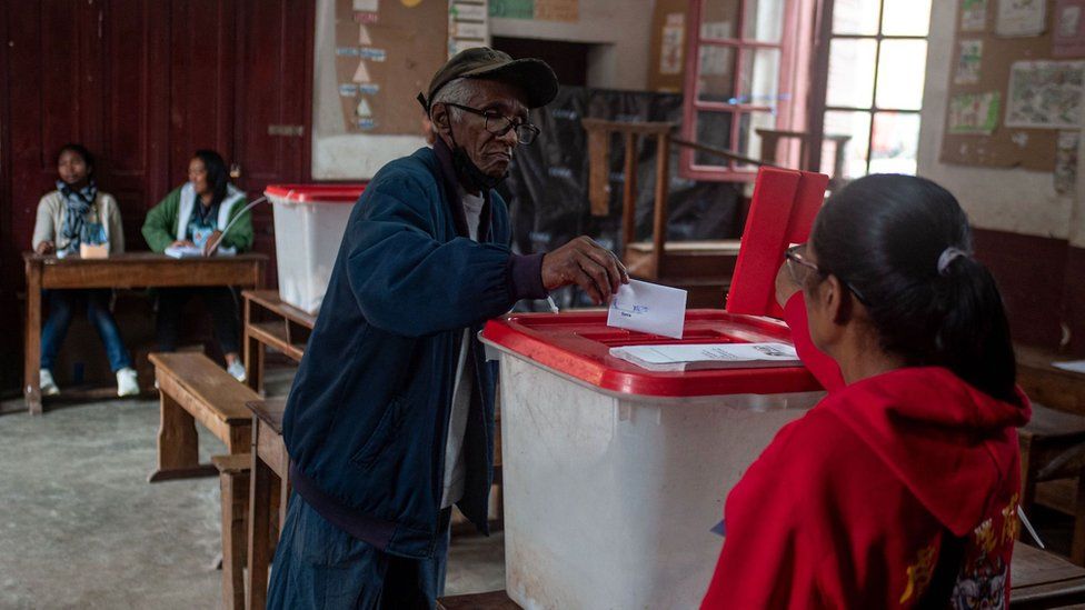 A man casts his ballot in the box