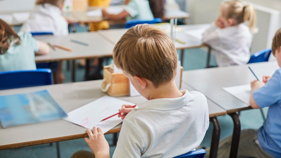 Primary schoolhouse  children doing schoolwork astatine  schoolroom  desks