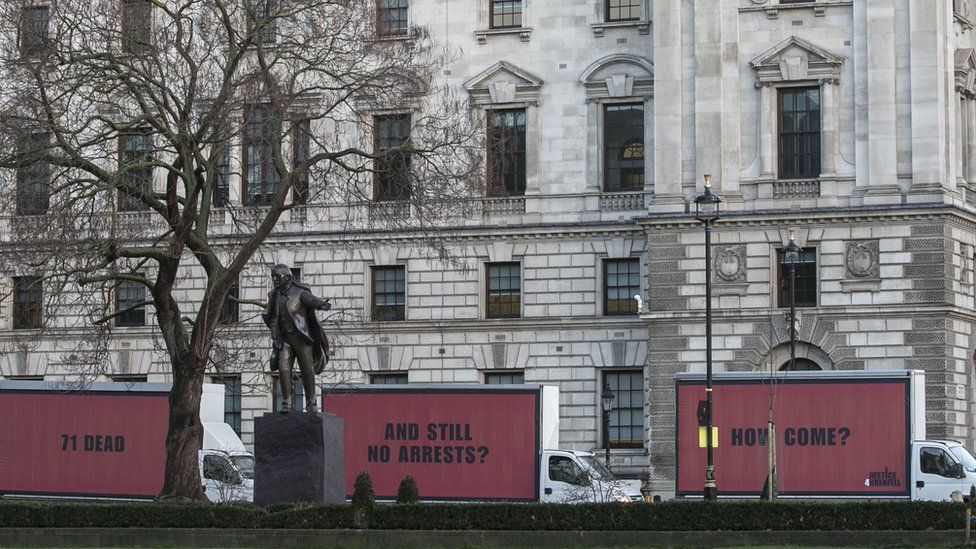 The three red and black billboards, which say: "71 dead. And still no arrests. How come?"