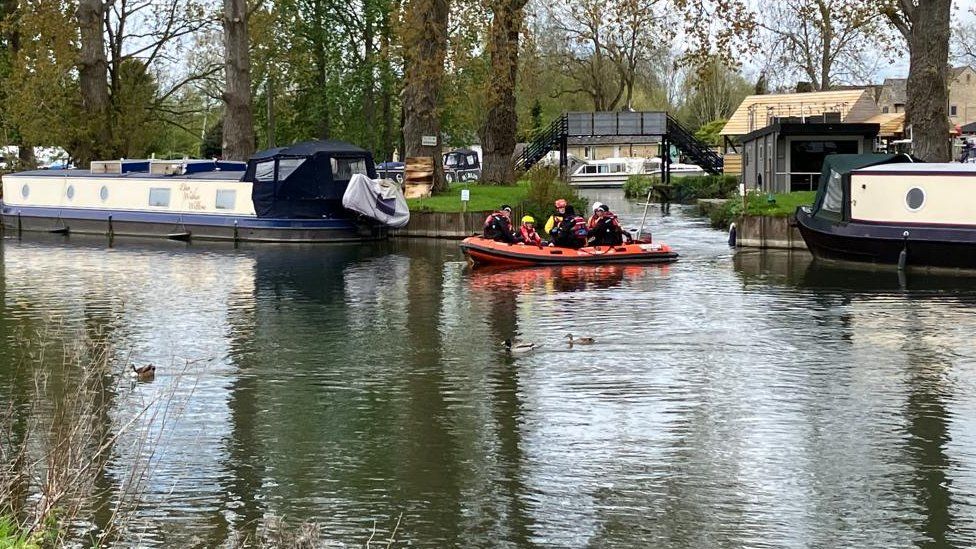 Lifeboat searching for lad  connected  a river