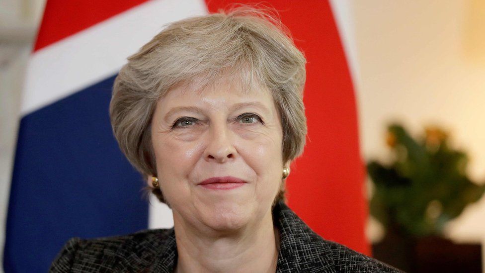 Theresa May in front of a union flag