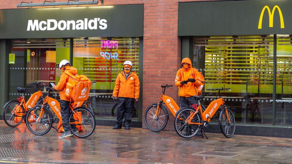 Just Eat Takeaway riders outside of a McDonald's outlet.