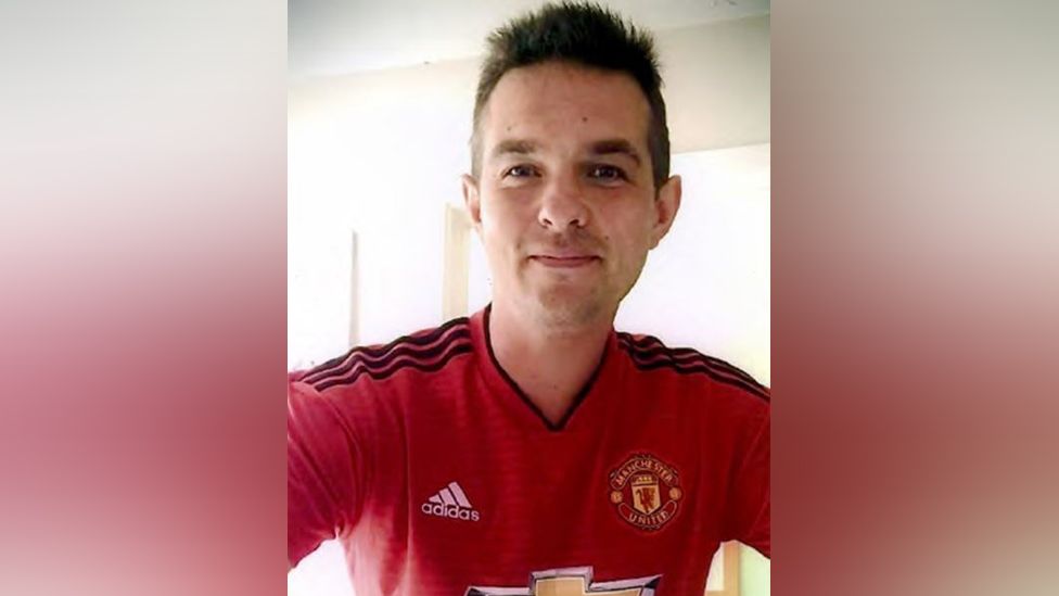 Nicholas Billingham wearing a Manchester United football shirt