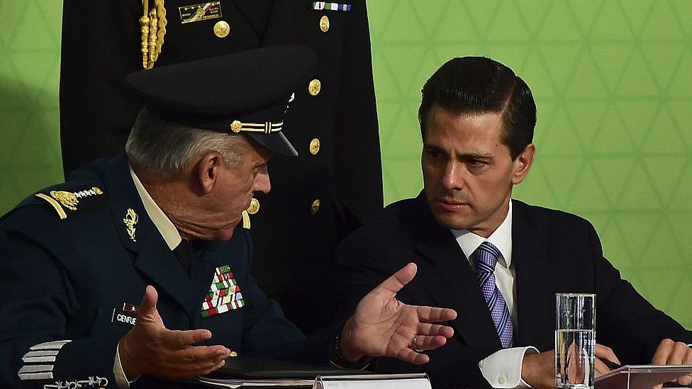 President Enrique Pena Nieto (R) speaks with General Salvador Cienfuegos during a ceremony in Mexico City, on July 21, 2015
