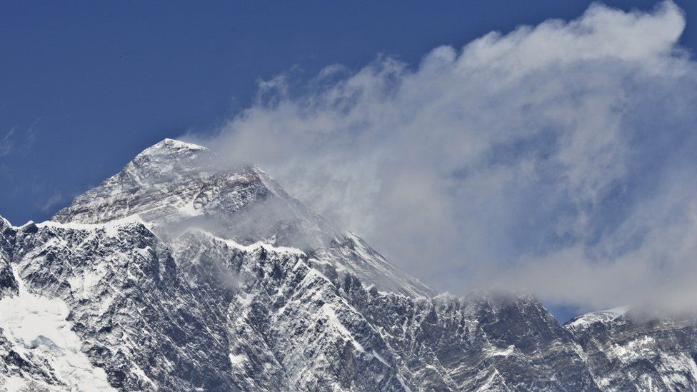 A view of Mount Everest (C-top) towering over the Nupse-Lohtse massif (foreground) from the village of Tembuche in the Khumbu region of northeastern Nepal (file photo)