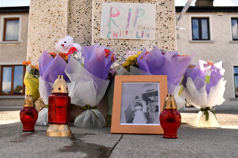 Flowers, photos and candles left at the scene of the incident as tributes to the three young people who died