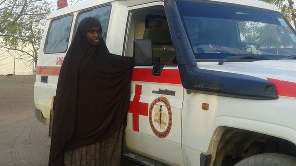 Bishara Farah stands next to her ambulance