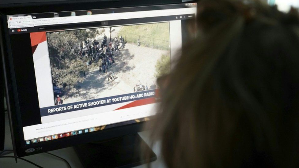 Journalist looking at a computer screen of Youtube shooting report