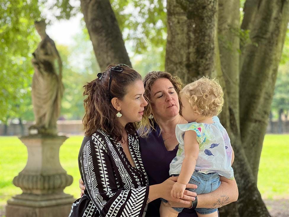 Valentina (L) and Daniela (R) are holding their daughter Caterina
