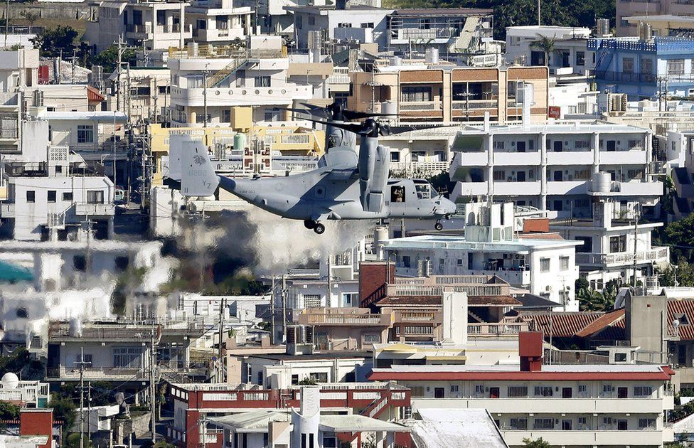 An Osprey tilt-rotor aircraft flies over Ginowan, as it heads for the U.S. Marine Corps Futenma Air Station for additional deployment of Osprey, Okinawa Prefecture, Japan, in this photo taken by Kyodo 13 August 2013.