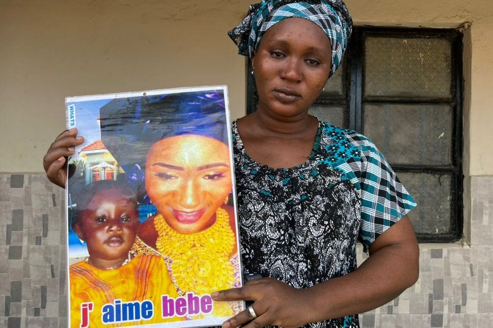 Mother with a poster of her child