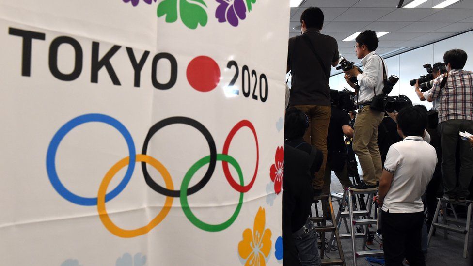 Photographers take pictures during a panel at the Tokyo 2020 organising committee headquarters in Tokyo