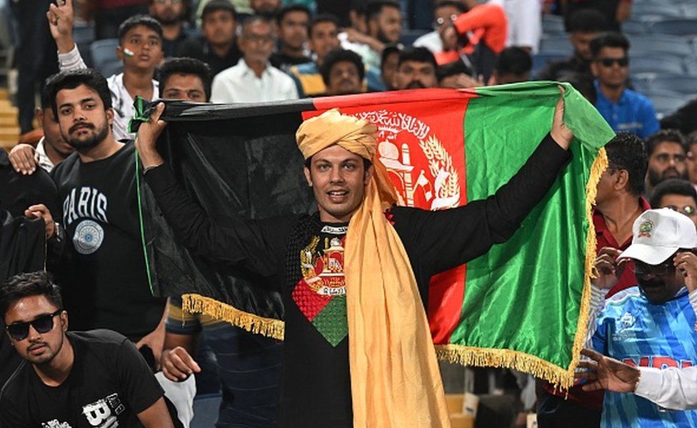 Afghanistan fans cheer while watching the 2023 ICC Men's Cricket World Cup one-day international (ODI) match between Afghanistan and Sri Lanka at the Maharashtra Cricket Association Stadium in Pune on October 30, 2023