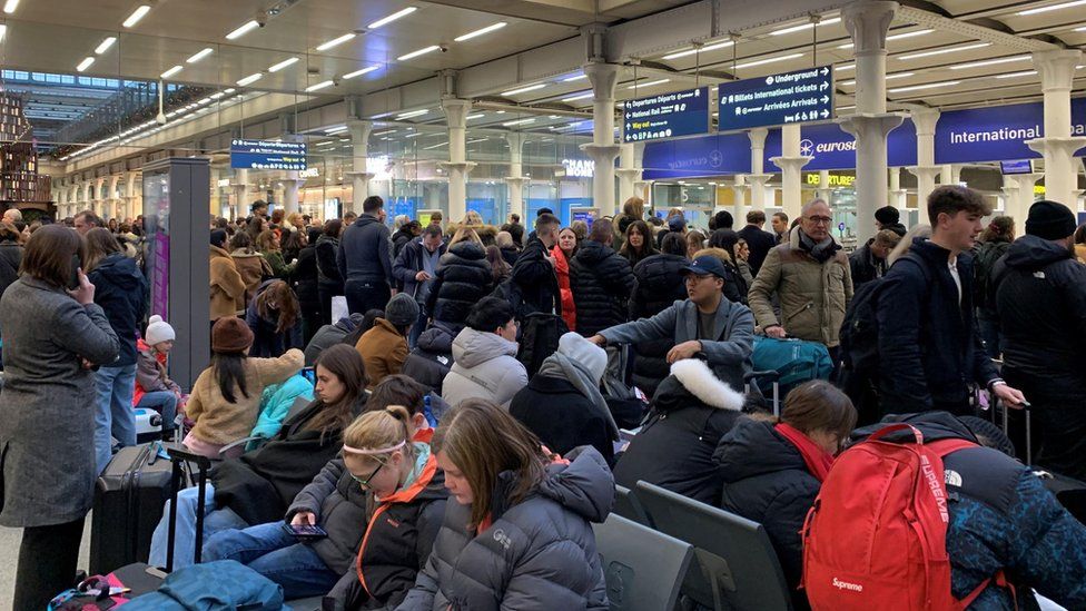 Passengers wait on the concourse at the entrance to Eurostar in St Pancras International station