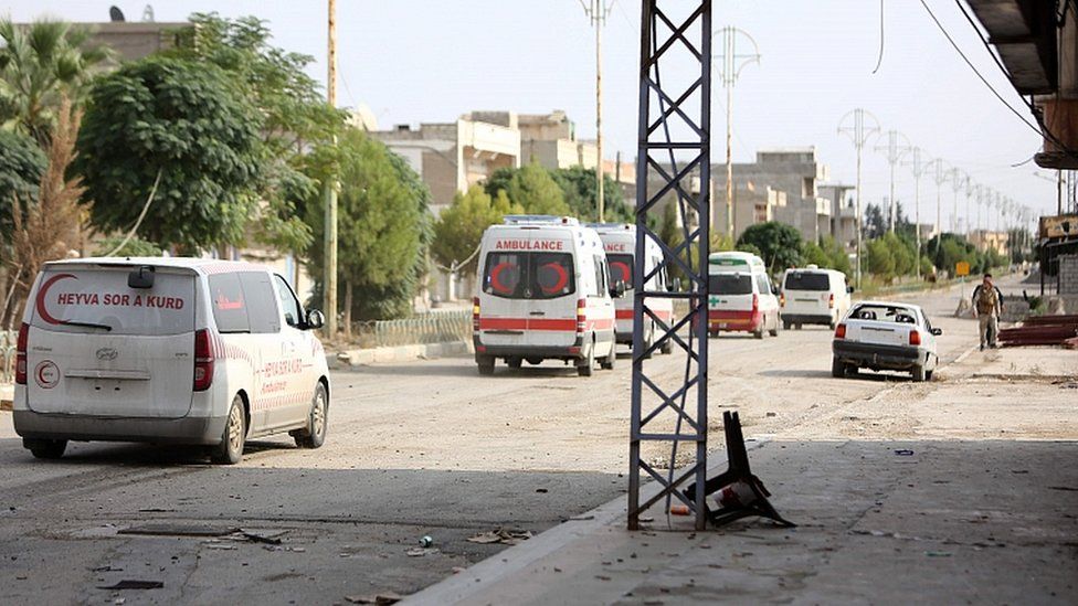 A convoy of ambulances and other vehicles leaves the north-eastern Syrian border town of Ras al-Ain on October 20, 2019