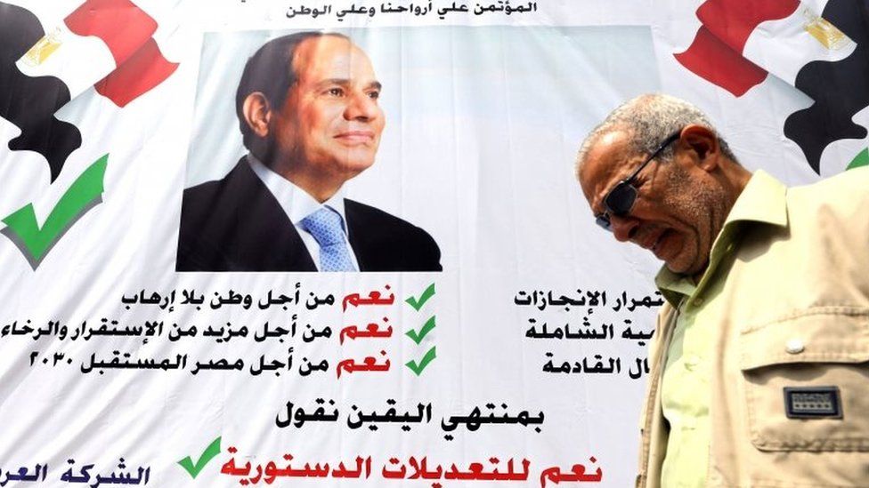 A man walks in front of a banner reading, "Yes to the constitutional amendments, for a better future", with a photo of the Egyptian President Abdel Fattah al-Sisi before the approaching referendum on constitutional amendments in Cairo, Egypt on 16 April 2019.