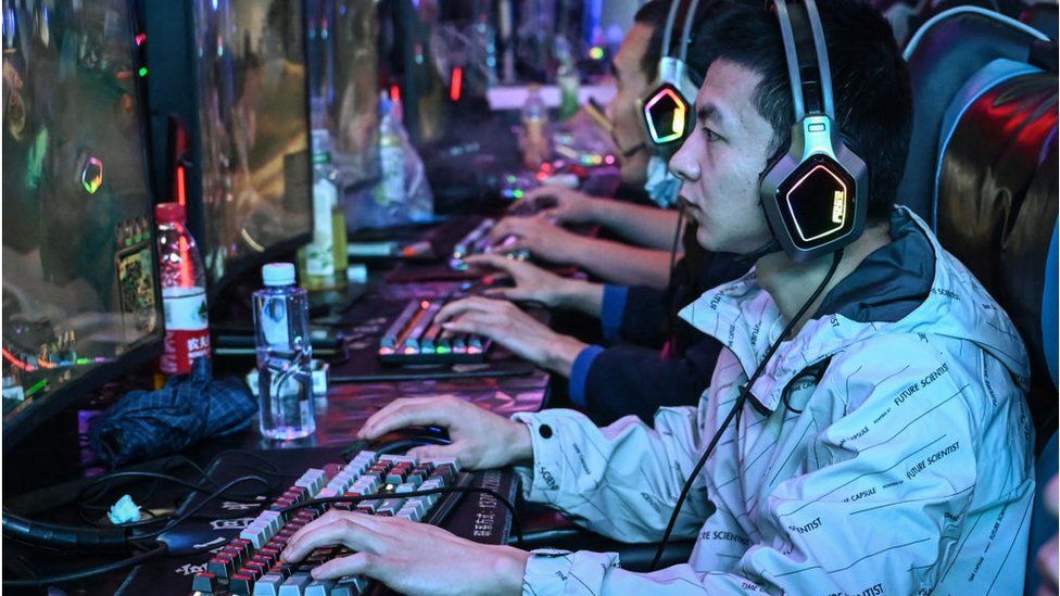 People play video games at an internet cafe in Beijing on April 10, 2024.