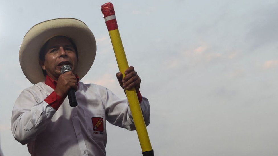 Peruvian left-wing presidential candidate for Peru Libre party, Pedro Castillo, delivers a speech as he holds a big pencil, symbol of the party during a rally on 25 May