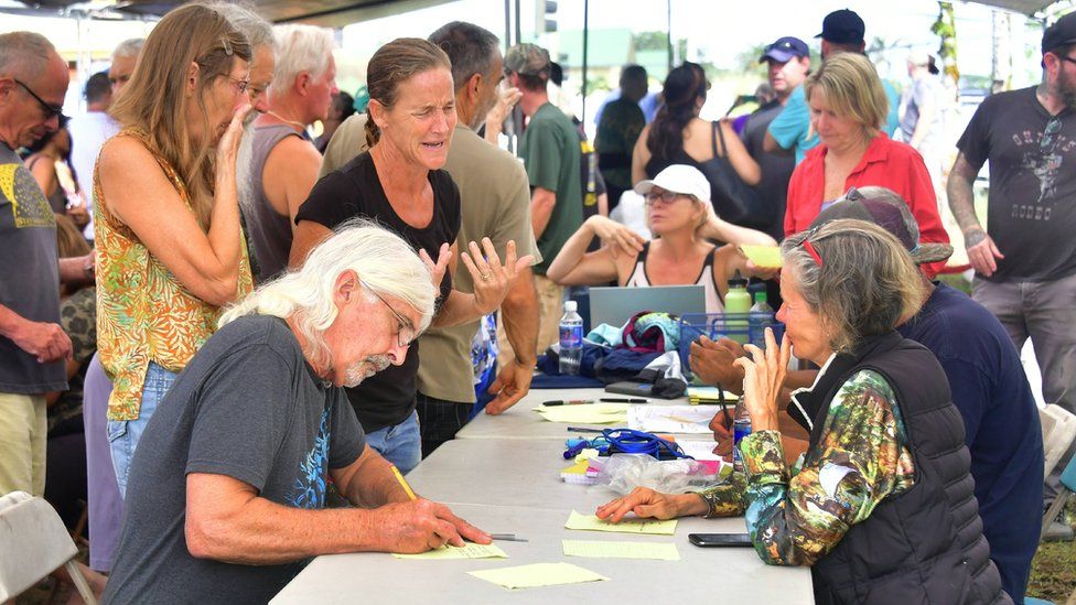 Evacuees fill out forms before being allowed to return to their Leilani Estates homes to gather belongings on May 6, 2018, near Pahoa, Hawaii.