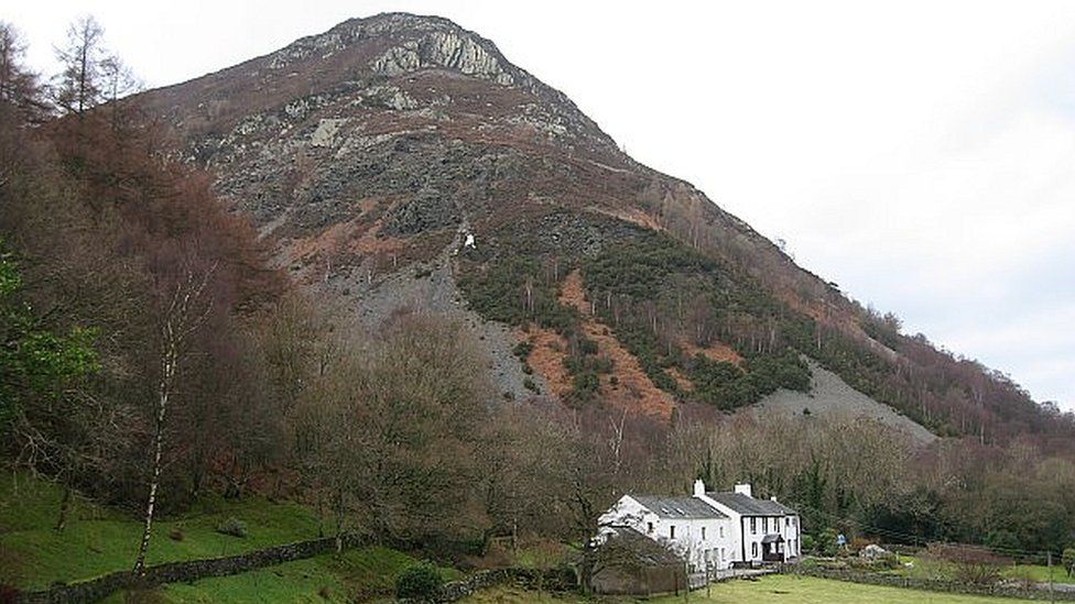 A large and steep hill rises