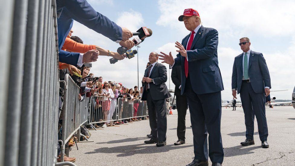 Former President Donald Trump speaks to the media as he arrives at the Atlanta Airport on April 10, 2024 in Atlanta, Georgia. Trump is visiting Atlanta for a campaign fundraising event he is hosting