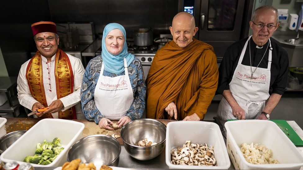 Krishan Kant Attri, Julie Siddiqi, Venerable Ajahn Amaro and the Archbishop of Canterbury Justin Welby prepare food as they join other faith leaders in taking part in the Big Help Out