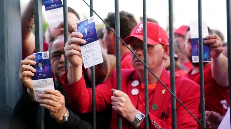 Liverpool fans show tickets outside the Stade de France, Paris