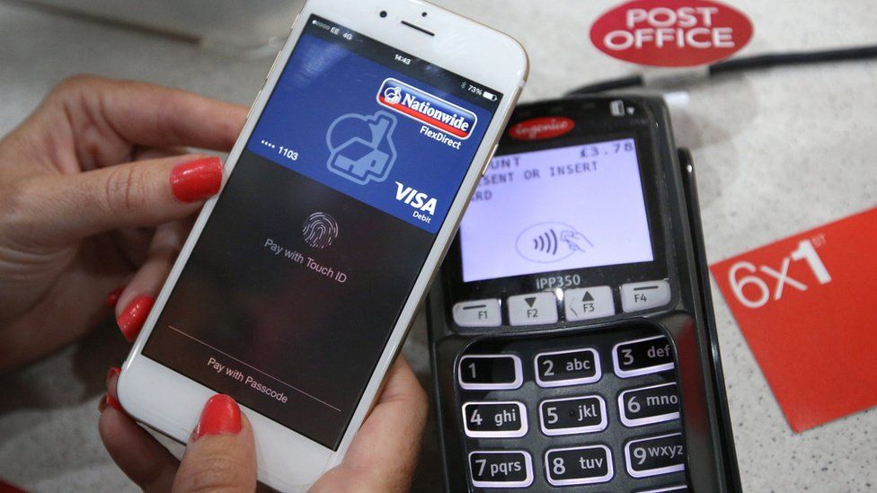An iPhone makes an Apple Pay purchase at the Post Office