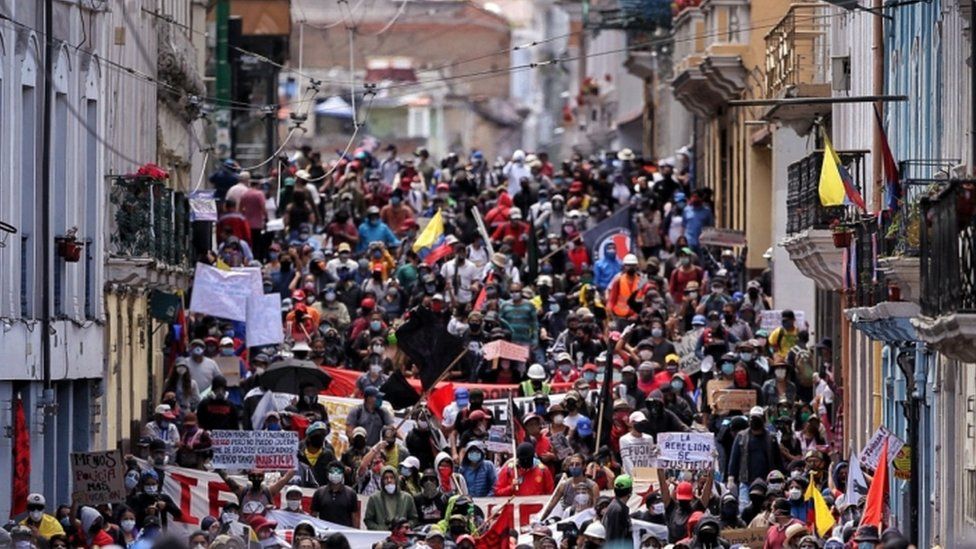 Thousands of protesters march through the streets of Quito