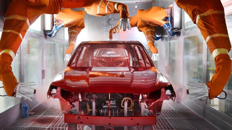 Robotic arms spray paint a car body shell at the BYD Automobile Company Limited Xi'an plant on December 25, 2019 in Xi'an, Shaanxi Province of China.