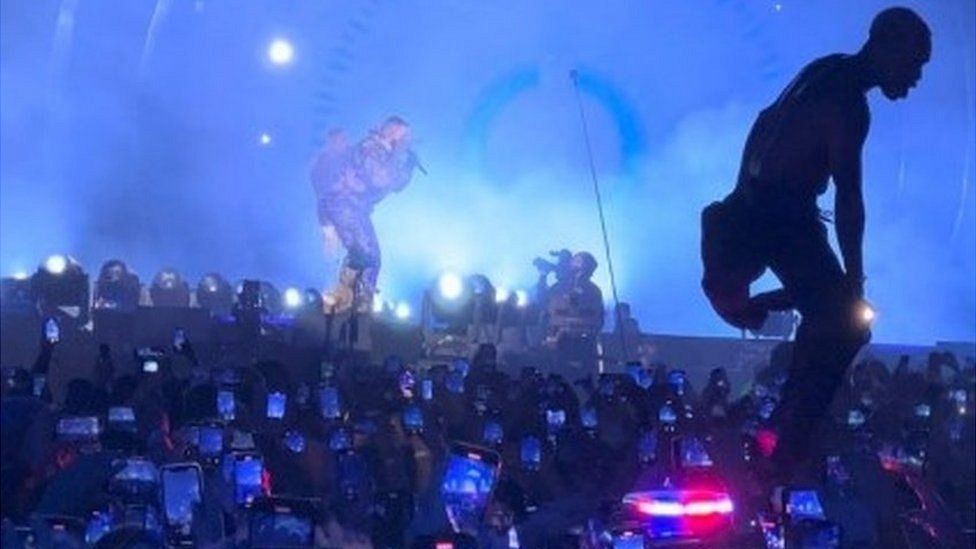 A man stands on an ambulance at the concert