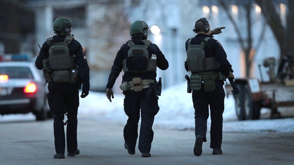 Police secure the area following a shooting at the Henry Pratt Company in Aurora, Illinois, 15 February 2019