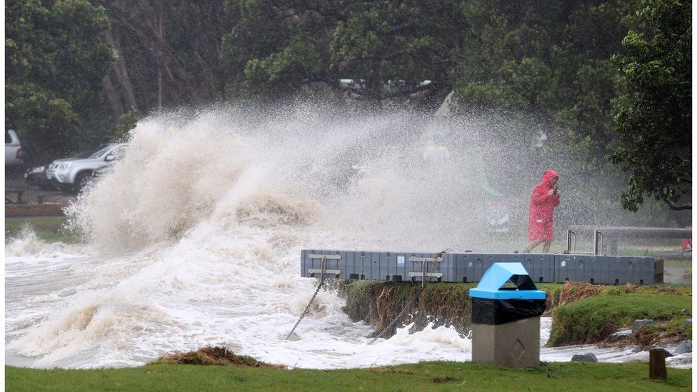 A person in a red raincoat at Mathesons Bay Beach