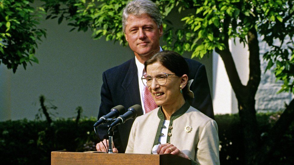 President Bill Clinton stands behind newly-confirmed Associate Justice of the Supreme Court Ruth Bader Ginsburg as she speaks in the Rose Garden of the White House, Washington DC, 3 August 1993